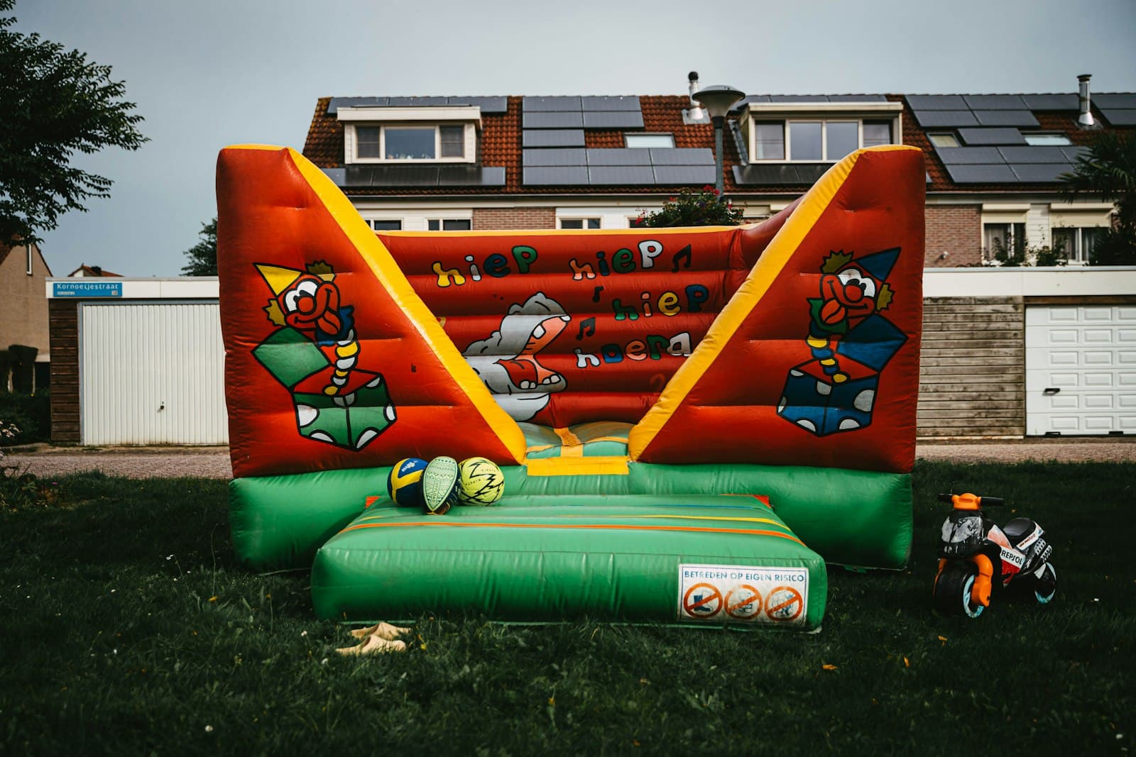 A large inflatable bounce house set up in a yard